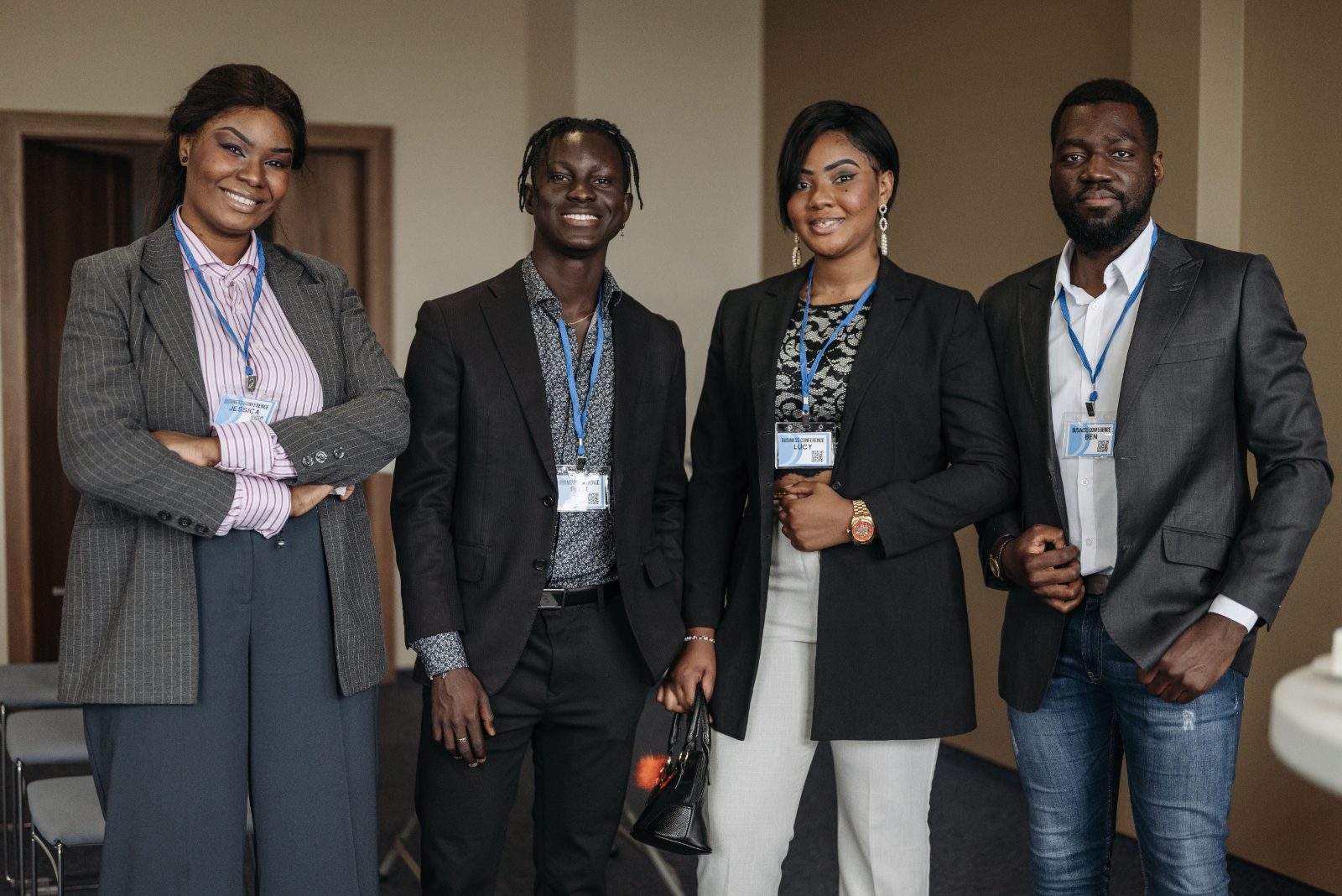 Four young professionals standing together at a business conference